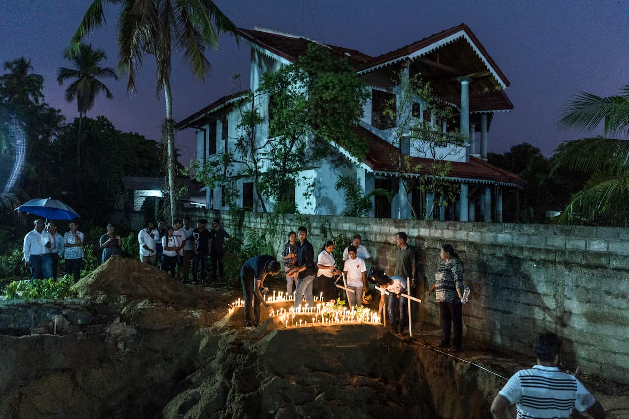 Mourners grieve in Negombo, Sri Lanka, on Monday, April 22, 2019, at the burial of three members of the same family who were killed in the suicide bomb attack at St. Sebastian Church. 