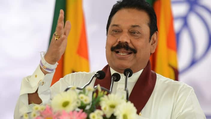 A man speaking at a microphone.