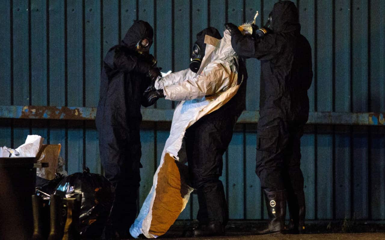 Police officers remove their protective suits on an industrial site as they continue investigations into the poisoning of Sergei Skripal in Salisbury