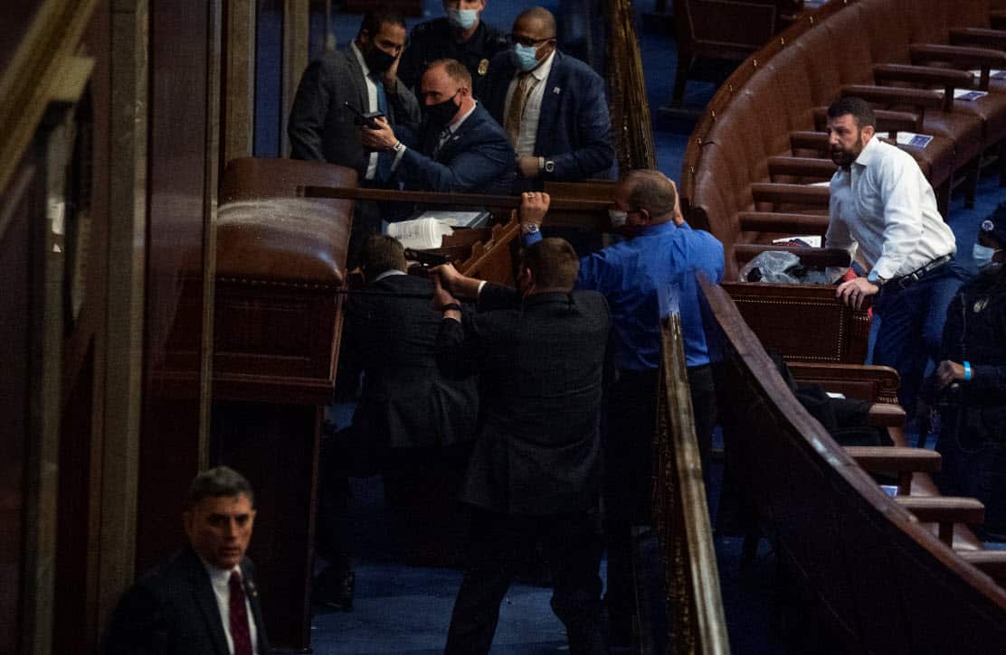 Security barricades the door of the House chamber om 6 January.