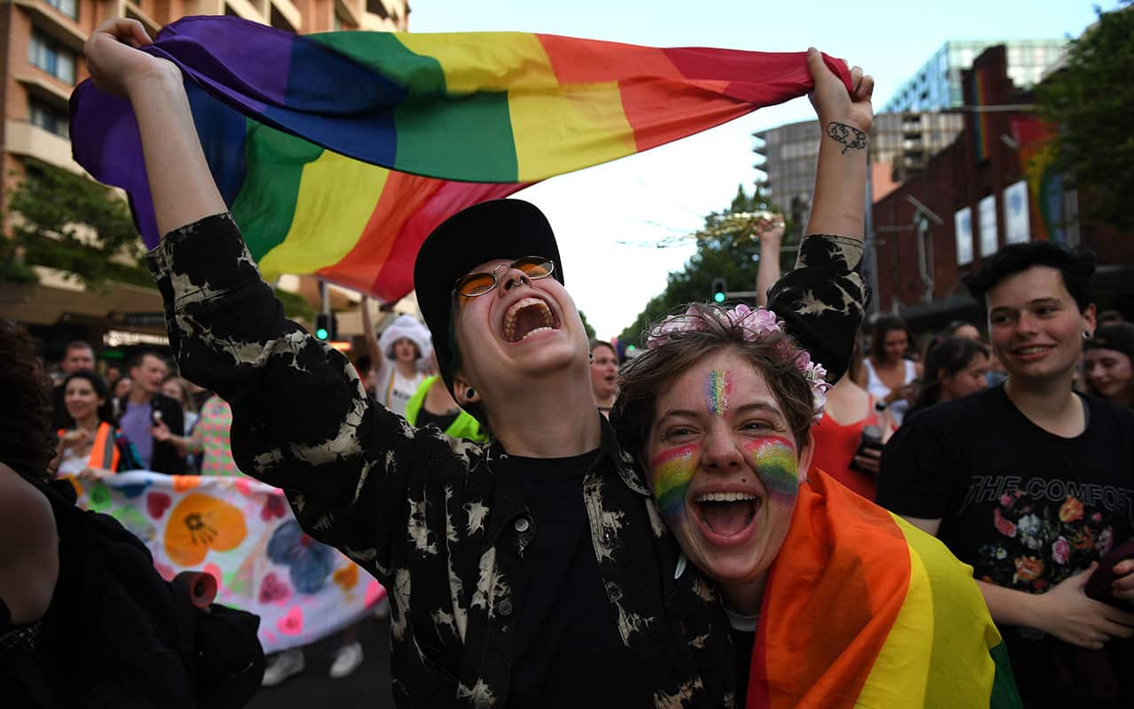 Revellers are seen marching down Oxford Street, following the announcement of the same sex marriage vote result, in Sydney.