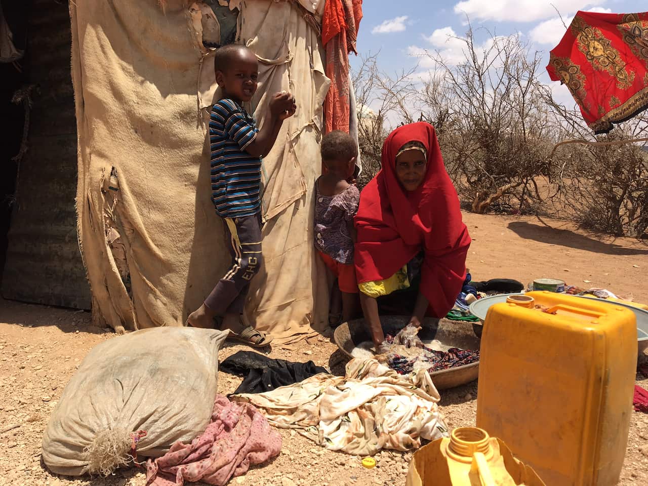 Children gather with their mother (SBS)