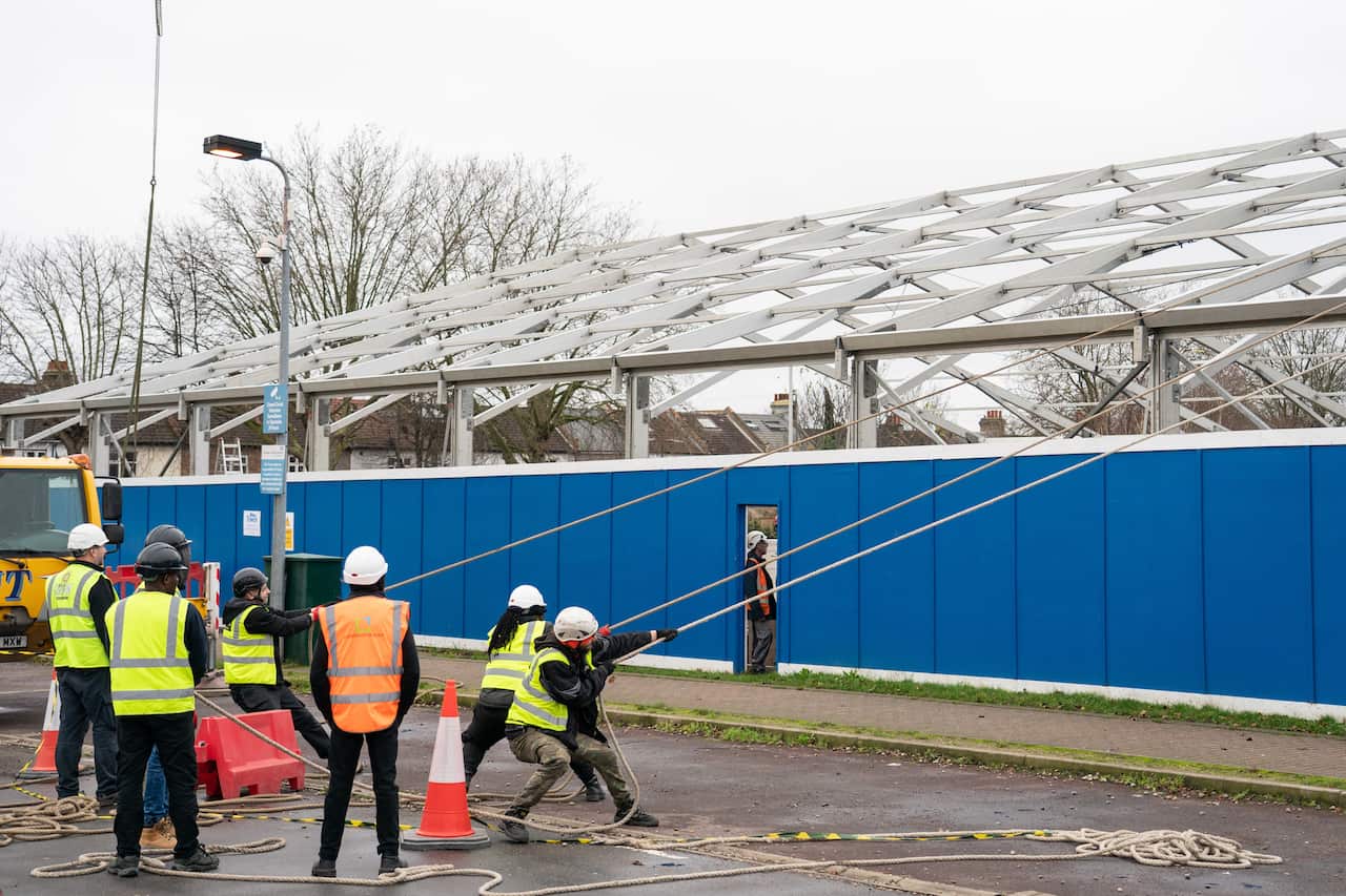 Construction workers at work building a Nightingale 'surge hub' at St George's Hospital, in south west London on 30 December, 2021.