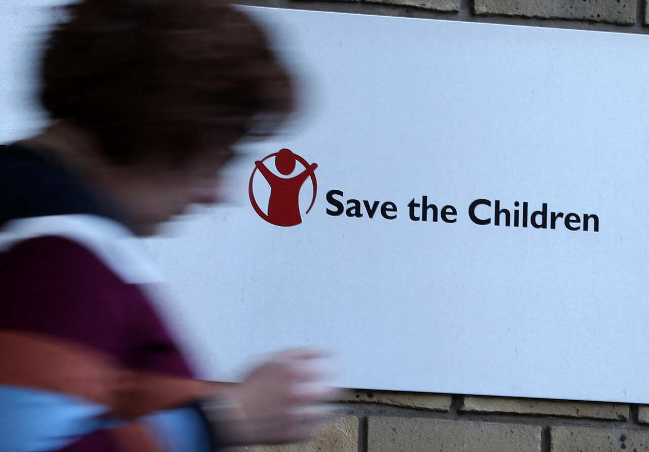 A Save the Children logo is seen outside the organisation's offices in central London on 15 February, 2018. 