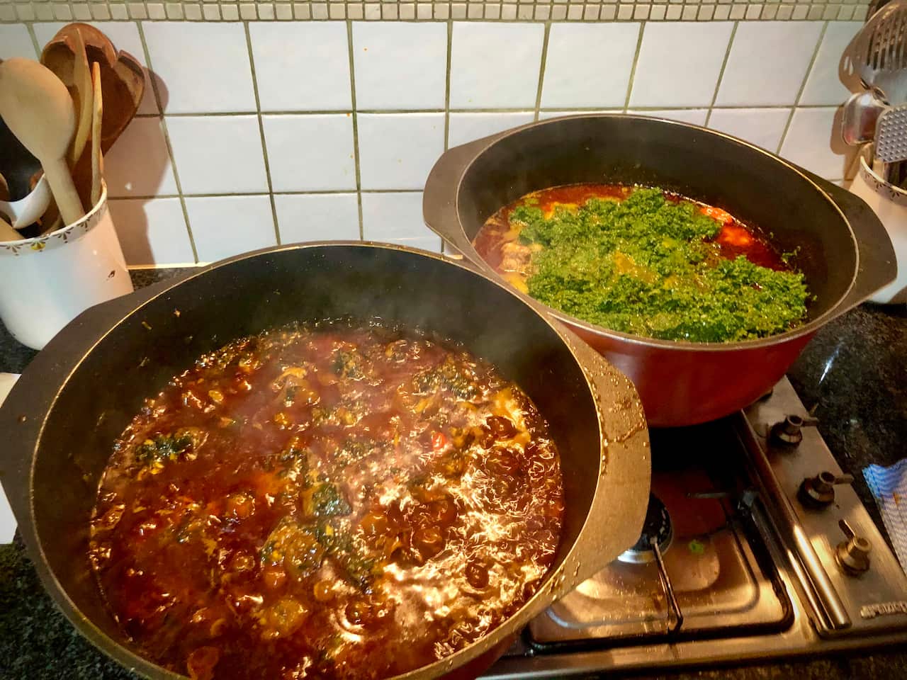 In front is potato leaf stew and behind is cassava leaf stew