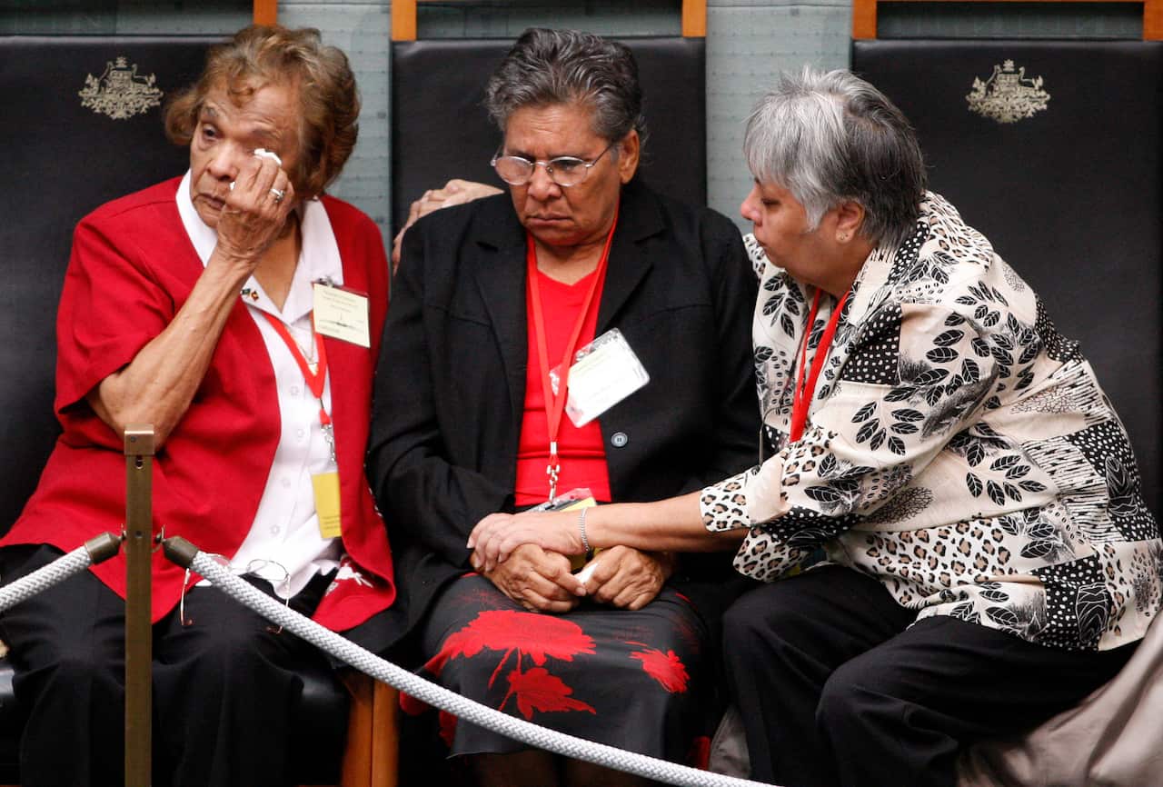 A member of Australia's Stolen Generation wipes tears away as they listen to Prime Minister Kevin Rudd deliver his apology. 