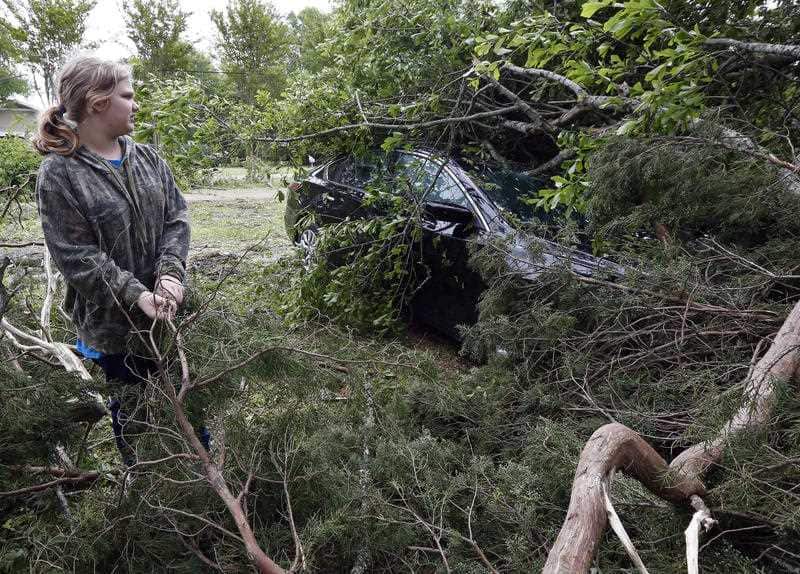 Kayla Easterling outside her church, with several damaged buildings. 