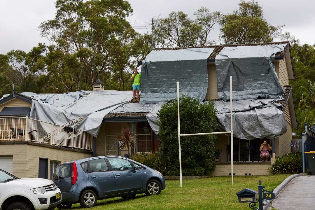 Tarps on the roof of a house that was damaged in a hail storm overnight in Berowra Heights.