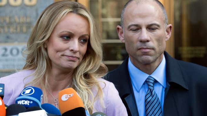 Adult film actress Stormy Daniels, left, stands with her lawyer Michael Avenatti.