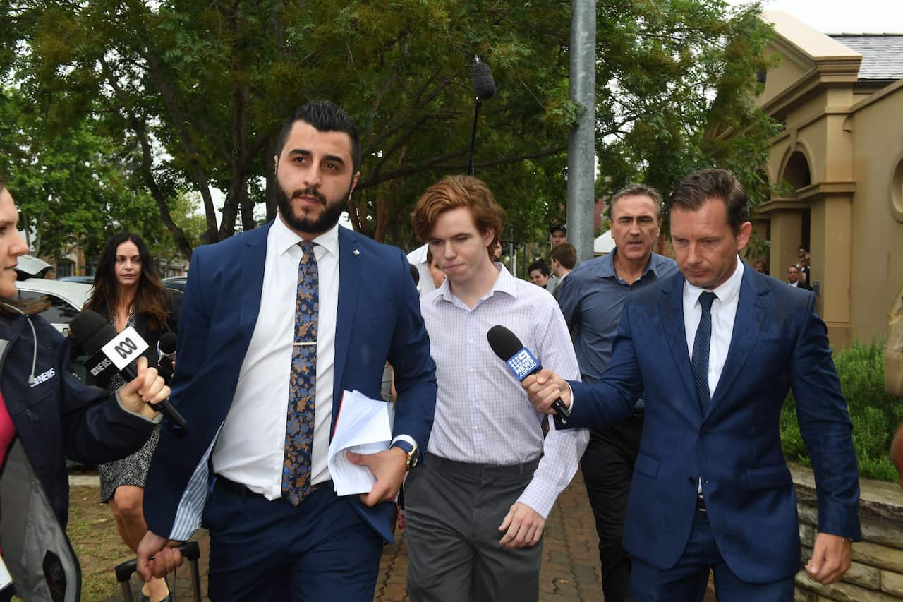Luke Munday (centre) leaves the Camden Local Court.