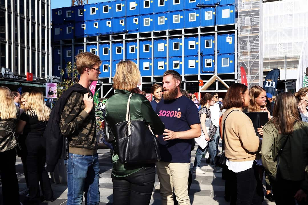 A member of the Sweden Democrats, a far-right party, speaks to potential voters at a gathering in Stockholm for representatives of all the political parties on Aug. 29, 2018.