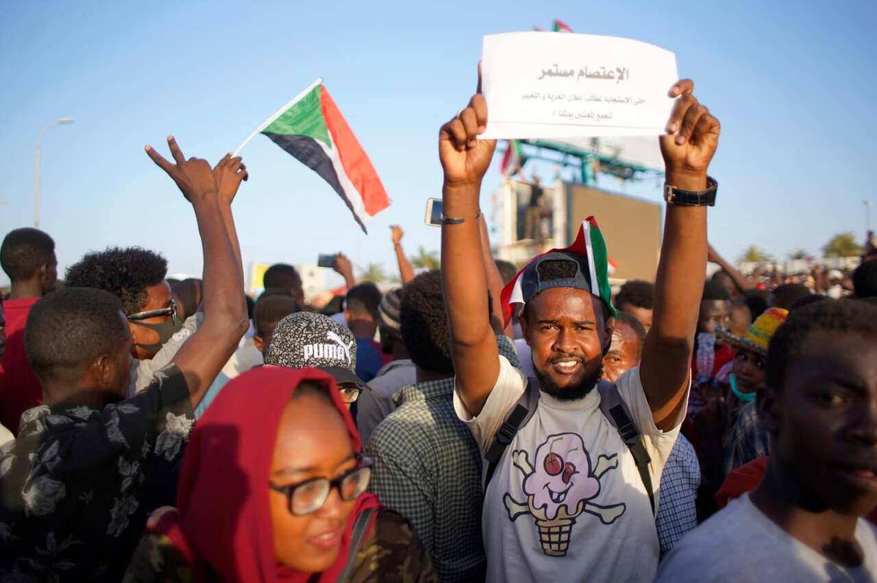 People chant slogans during a protest outside of the Military headquarters in Khartoum, Sudan, 13 April 2019. 