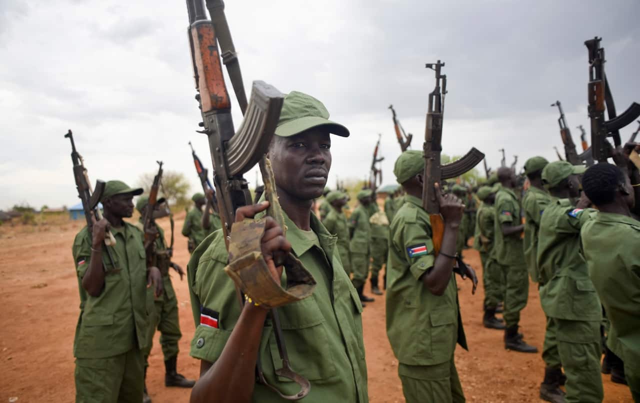 South Sudanese rebel soldiers raise their weapons at a military camp in the capital Juba, South Sudan