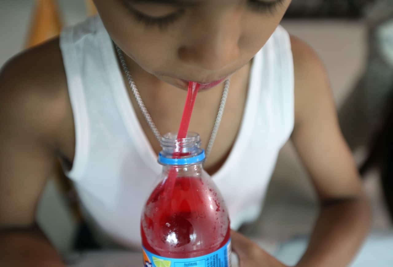 A Thai child consumes a soft drink in Bangkok, Thailand.