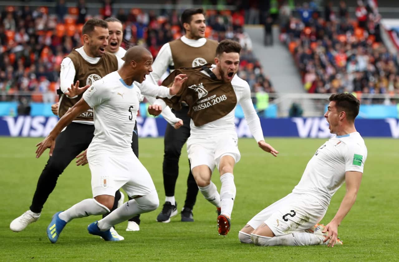 Jose Gimenez of Uruguay celebrates after scoring his team's first goal with team mates during the 2018 FIFA World Cup Russia group A match 