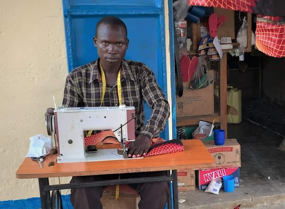 Sunday Ambayo is reskilling as a tailor.