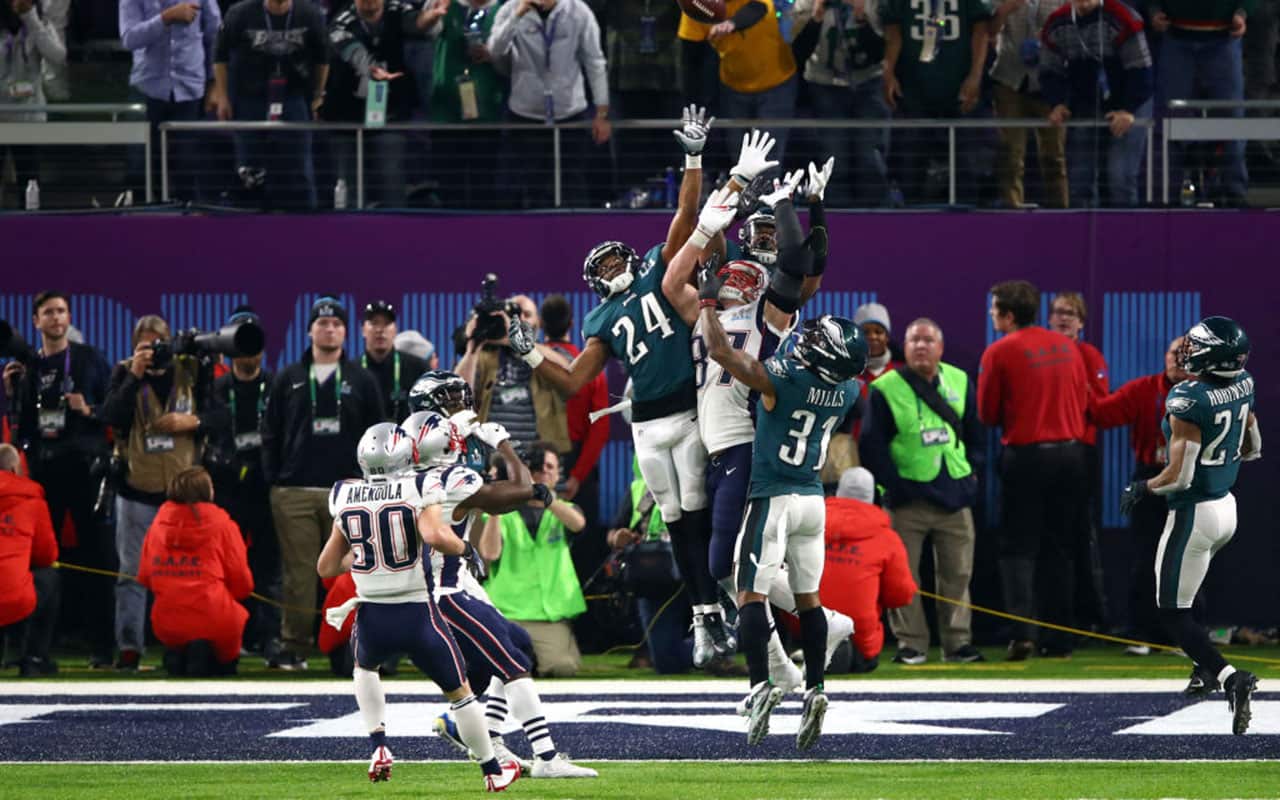 Corey Graham #24 and Jalen Mills #31 of the Philadelphia Eagles go up for a hail mary against Rob Gronkowski #87 of the New England Patriots.