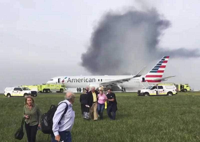 Passengers walk away from a burning American Airlines jet that aborted takeoff and caught fire on the runway at Chicago's O'Hare International Airport in 2016.