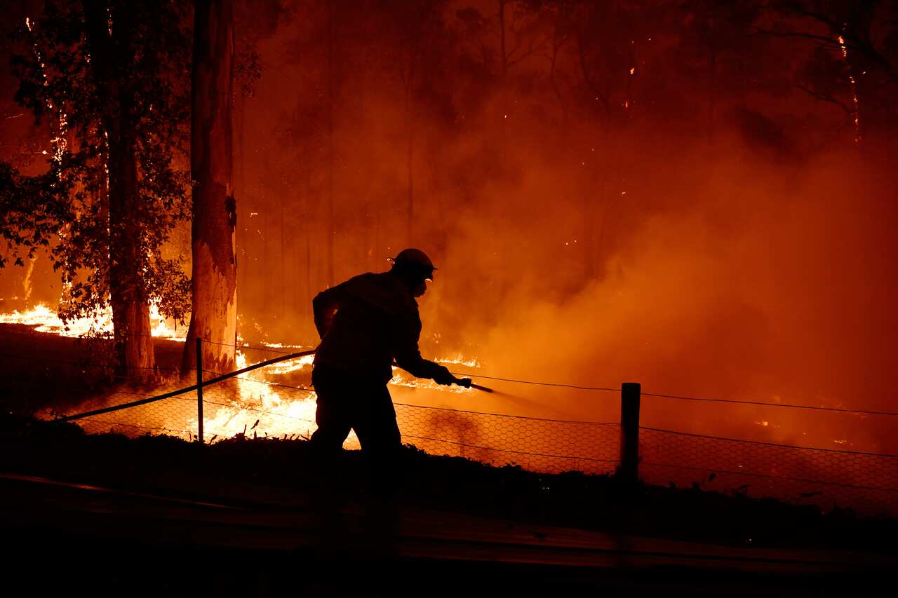 RFS volunteers and NSW Fire and Rescue officers protect the Colo Heights Public School.