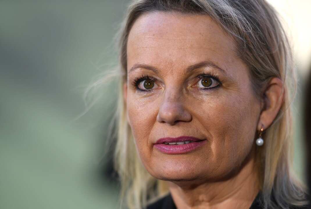 A woman is smiling at the camera.