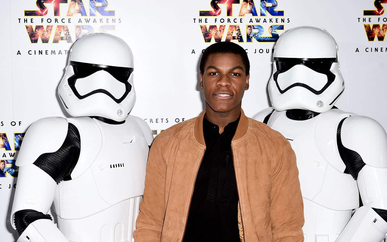 John Boyega alongside two Storm Troopers 