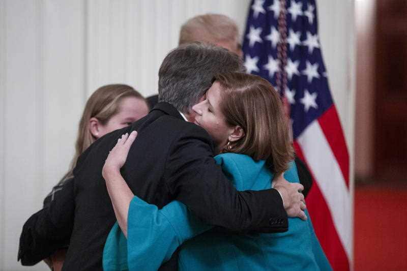 Supreme Court Associate Justice Brett Kavanaugh (L) hugs his wife Ashley after the ceremony.