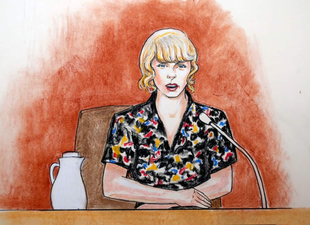 In this Thursday, Aug. 10, 2017, file courtroom sketch, pop singer Taylor Swift speaks from the witness stand during a trial, in Denver.