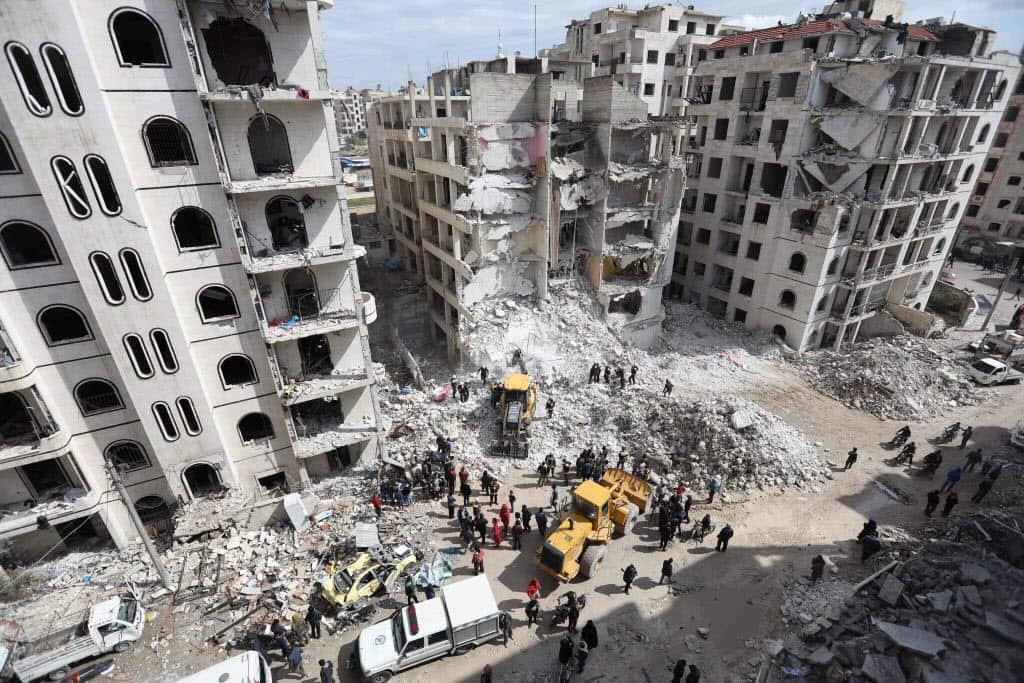 Syrian rescue teams clear the rubble in the morning of April 10, 2018 at the site of an explosion of unknown origin which wrecked a multi-storey building.