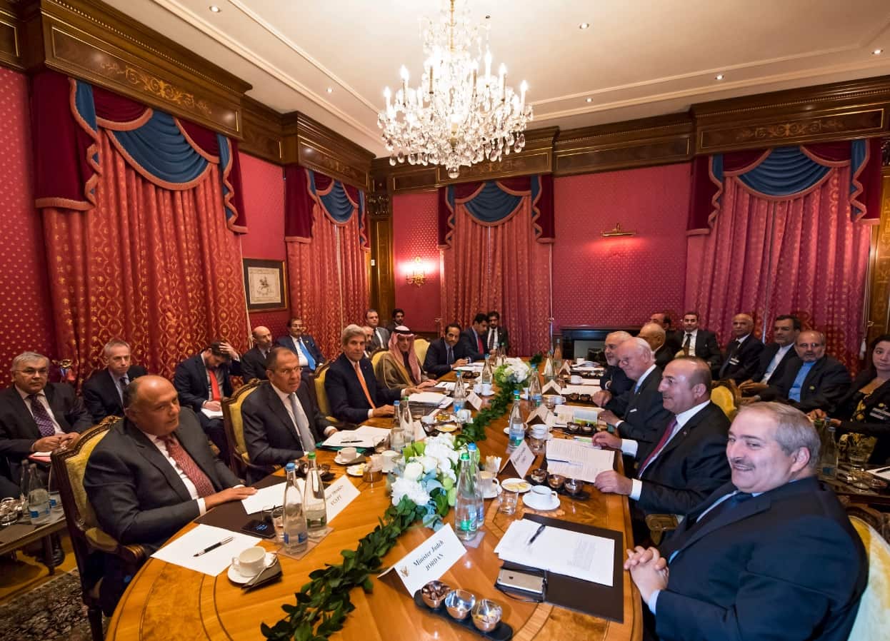 The delegation together around a table during a meeting where they discussed the crisis in Syria, in Lausanne, Switzerland (AAP)