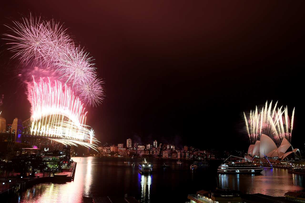The midnight fireworks light up Sydney Harbour and the Sydney Harbour Bridge during New Years Eve celebrations in Sydney.