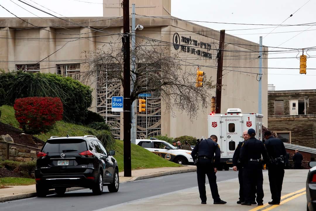 First responders stand outside the Tree of Life Synagogue in Pittsburgh, where a shooter opened fire Saturday, Oct. 27, 2018, injuring multiple people, including police officers. (AP Photo/Gene J. Puskar)