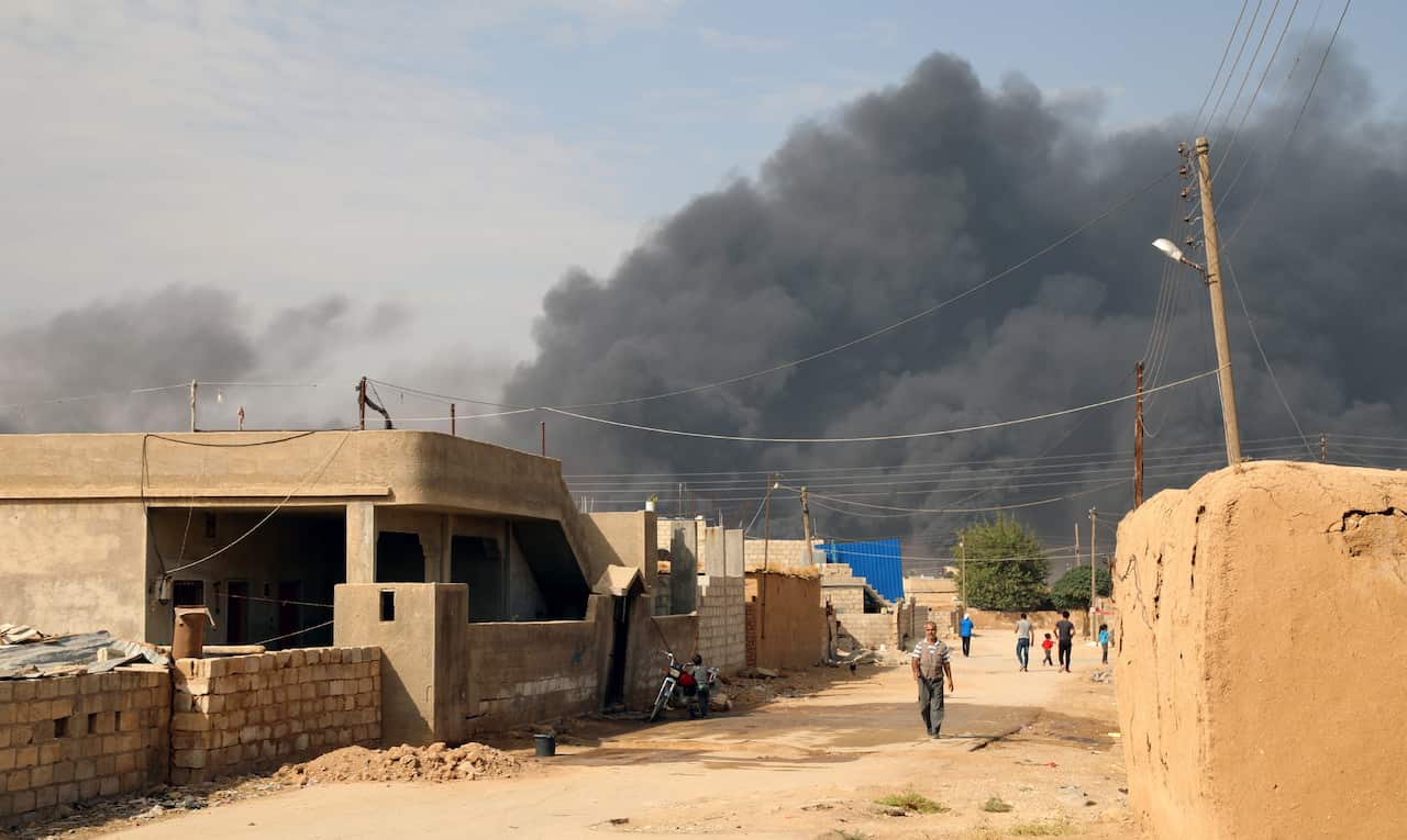 Smoke clouds rising from the scene of clashes between the Syria democratic forces (SDF) and Turkish troops and their Syrian opposition allies near Ras al-Ain.