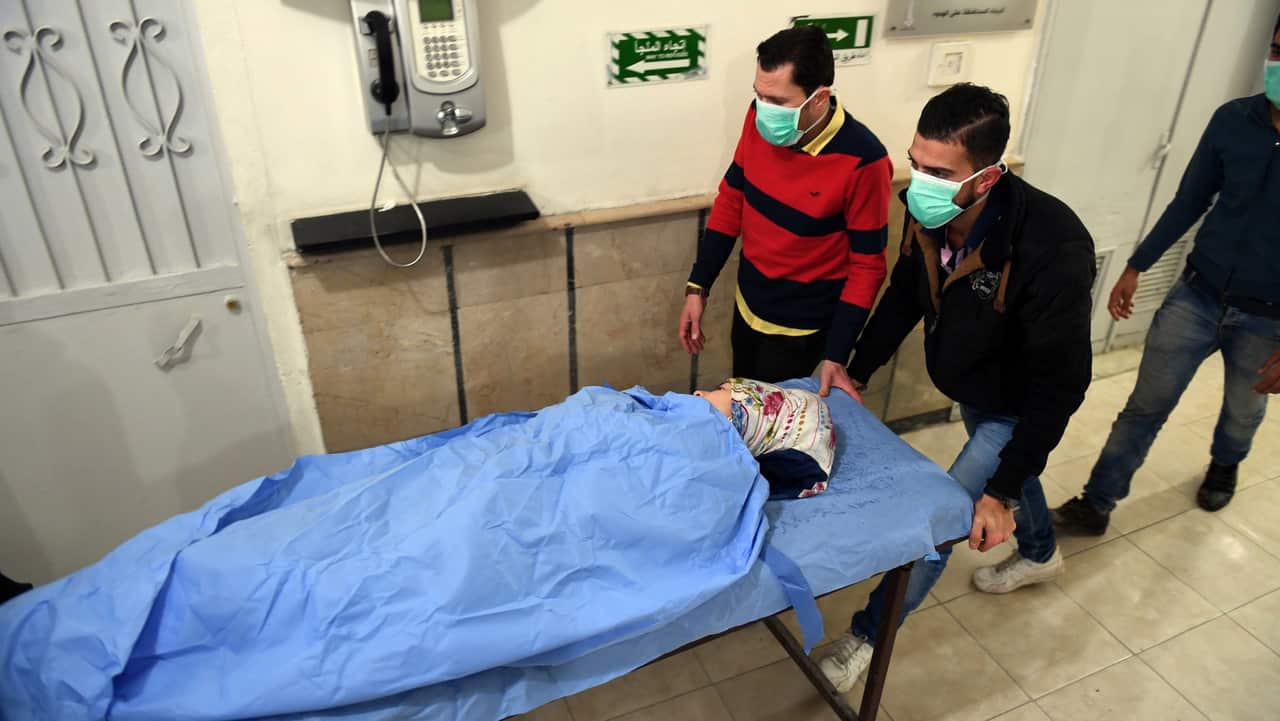 A photo from Syria's Arab News Agency shows people suffering suffocation symptoms laying on beds at al-Razi hospital in the northern city of Aleppo.