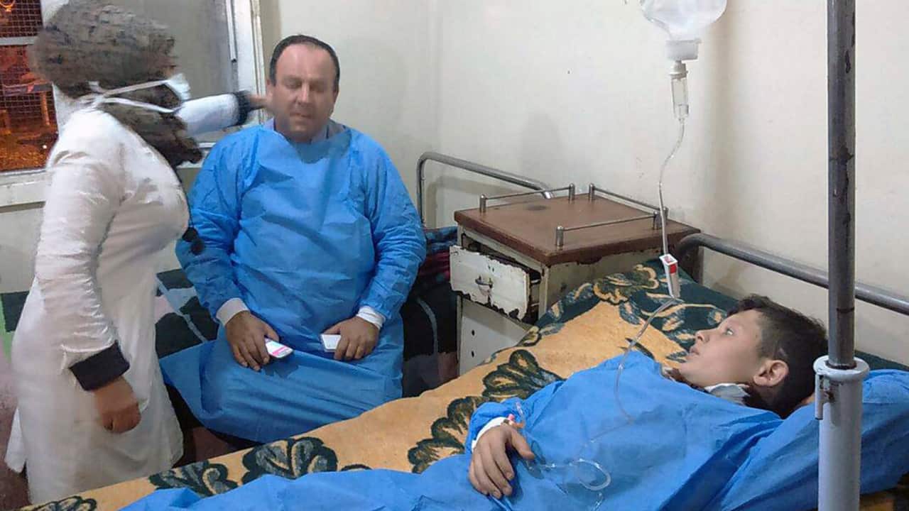 A photo released by the Syrian official news agency SANAshows people receiving treatment at a hospital following a suspected chemical attack in Aleppo. 