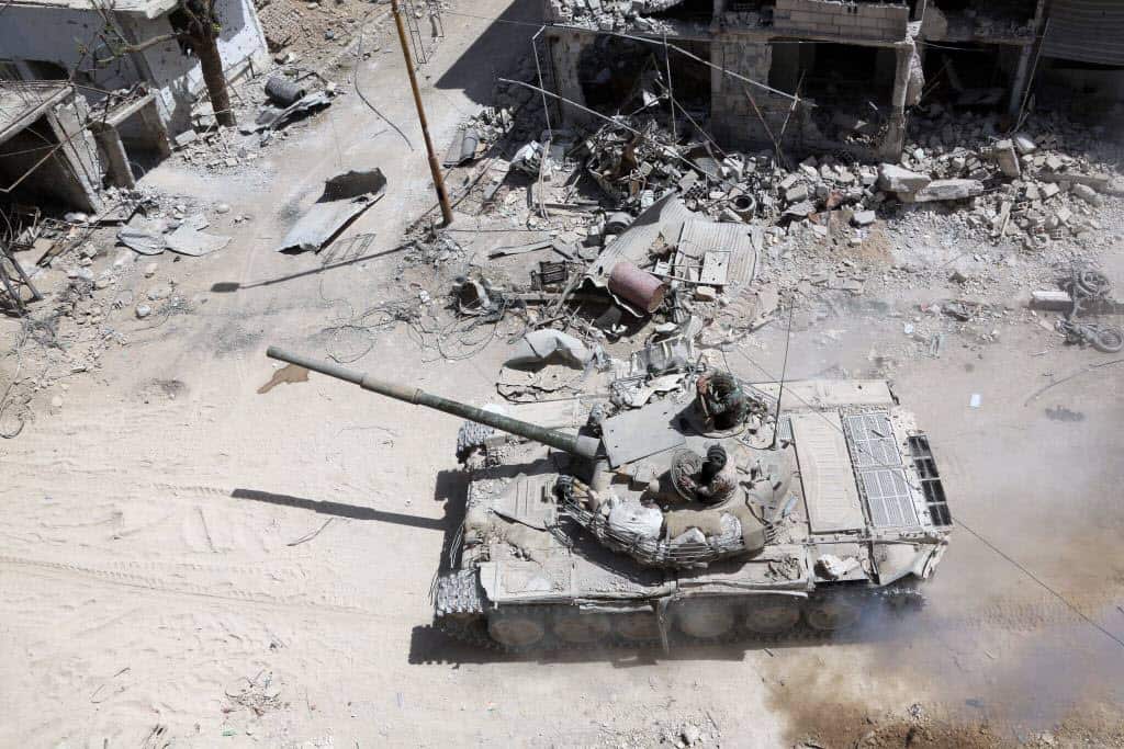 Syrian Army soldiers advancing in an area on the eastern outskirts of Douma.