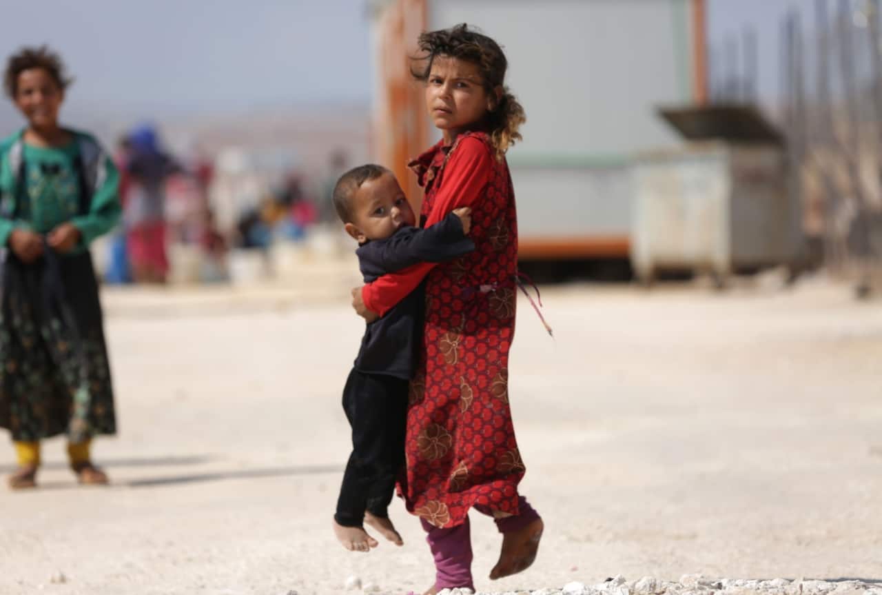 Children who fled Syria's Idlib province are pictured at a camp in Kafr Lusin near the border with Turkey in the northern part of the province on September 9, 2018