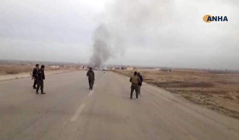 Kurdish fighters standing guard at the site of a suicide attack near the town of Shaddadeh, in Syria's northeastern province of Hassakeh.