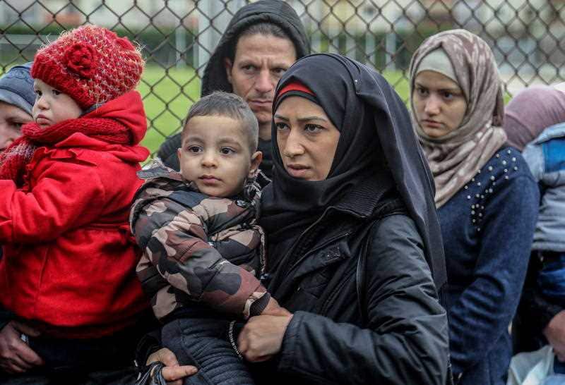 Syrian refugees gather as they wait to leave Beirut to return home to Syria.