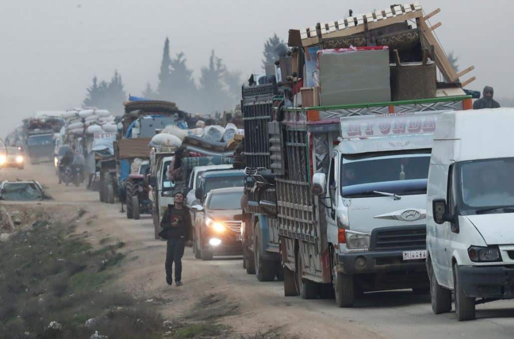 Trucks carrying displaced Syrians and their possessions as they flee nearby fighting. 