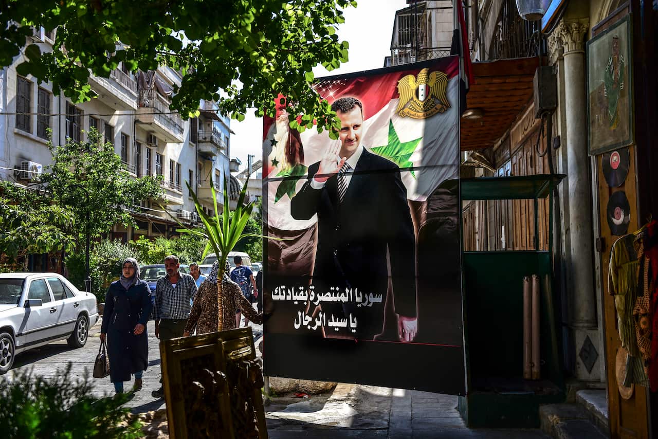 A large banner with the image of President Bashar Assad near a shop in the Old City of Damascus, Syria, June 24, 2019. (Meridith Kohut/The New York Times)