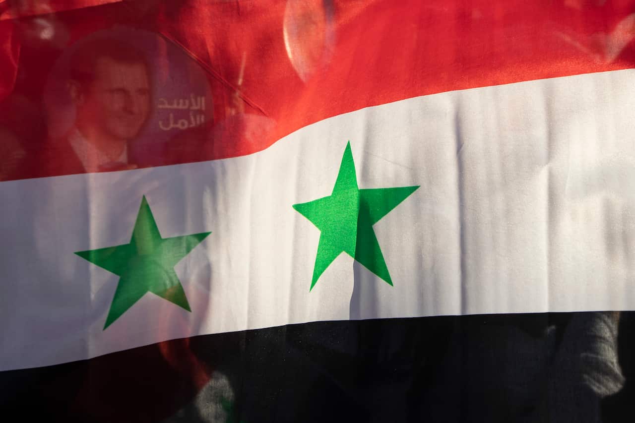  Syria's national flag is displayed at a gathering at Omayyid Square in the Syrian capital Damascus, Syria. 