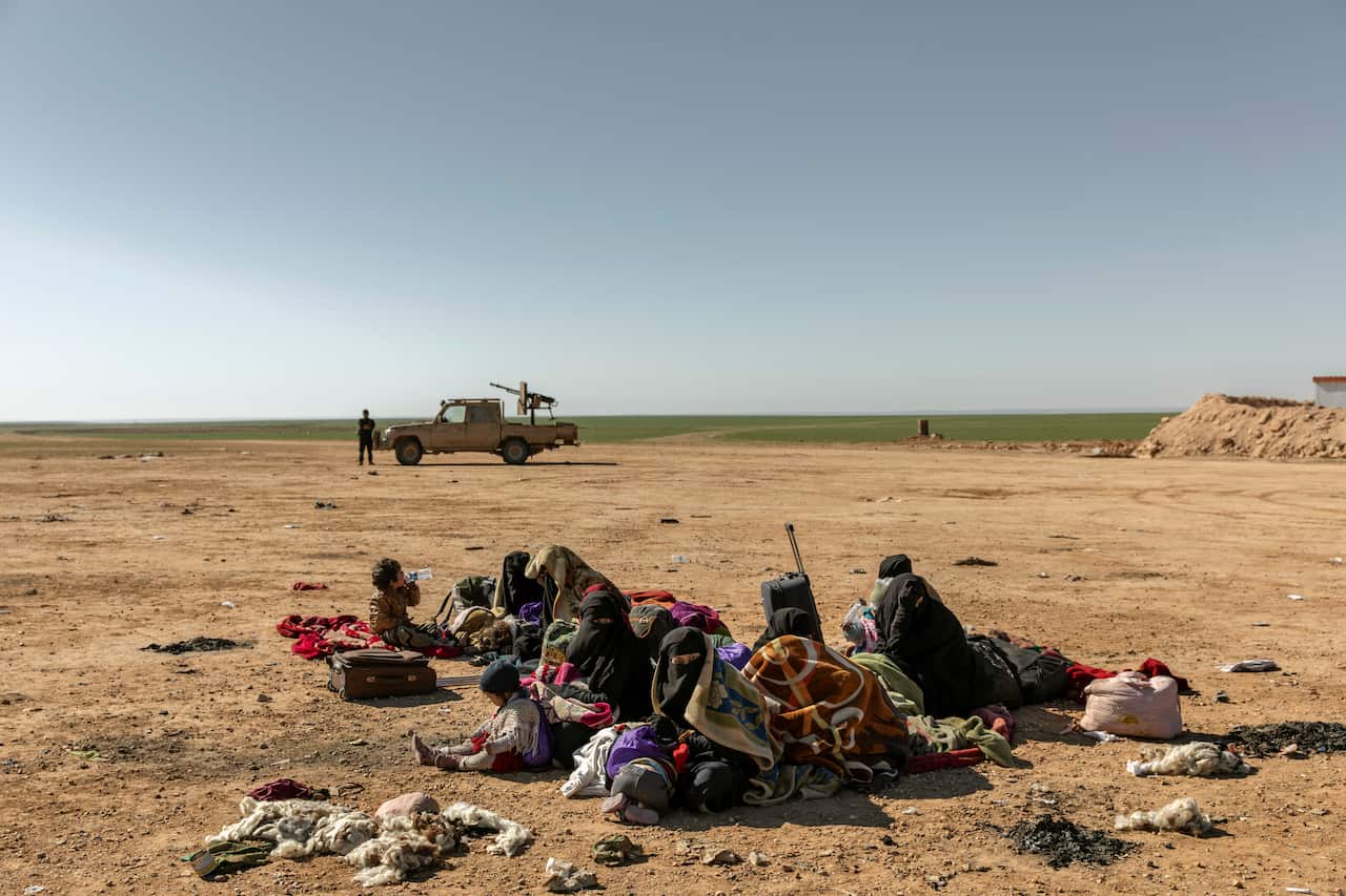 Women and children who had fled the last Islamic State-held area in southeastern Syria wait to be screened in Syria's Deir al-Zour province on Feb. 3, 2019.