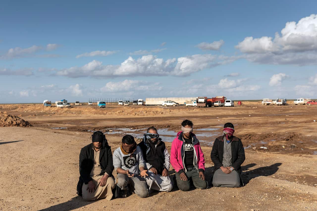 Men who had been arrested by Syrian Democratic Forces soldiers over suspected links to the Islamic State are held in Deir al-Zour province, Syria, on Jan. 30, 2019. 