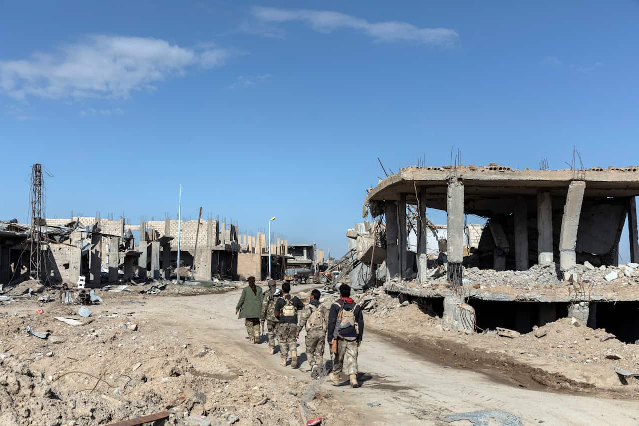 Local militiamen patrol the streets of Hajin, Syria, on Feb. 2, 2019.