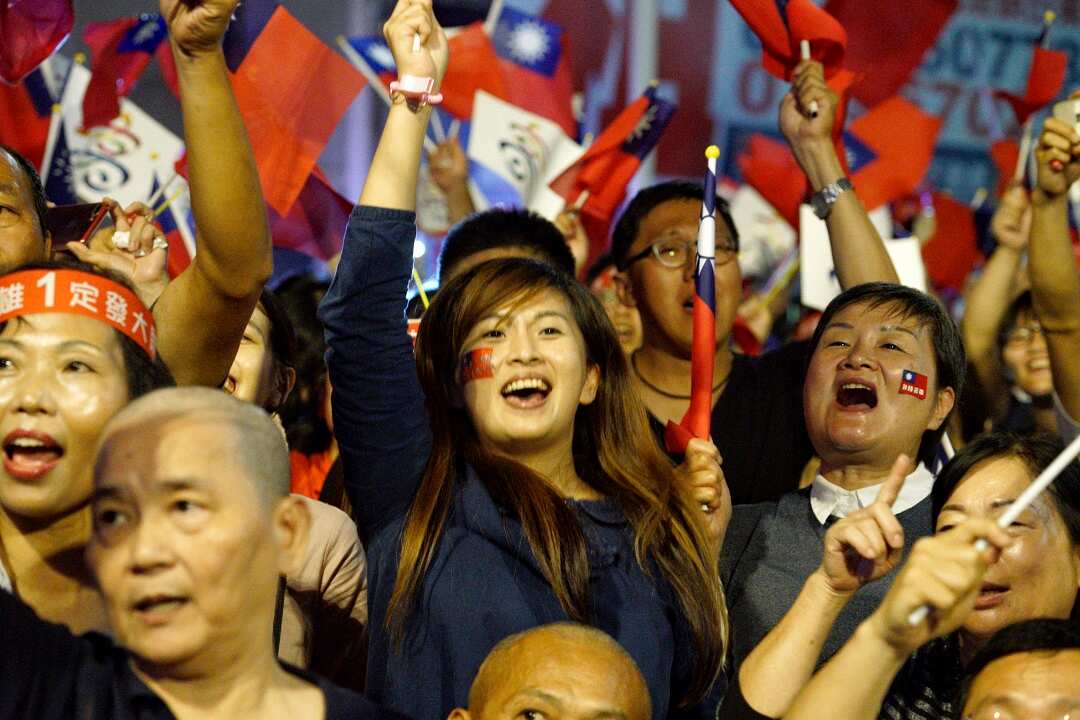Supporters of the opposition Nationalist Party celebrate in Kaohsiung after making gains in the local elections. 