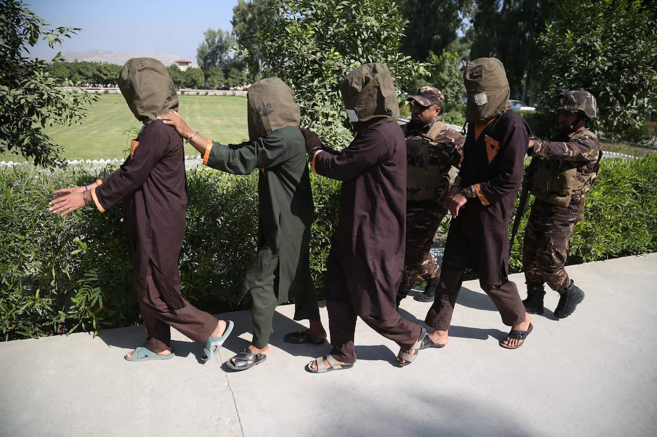 Afghan security forces lead away a group of suspected militants, who are accused of planning attacks on government and security forces.