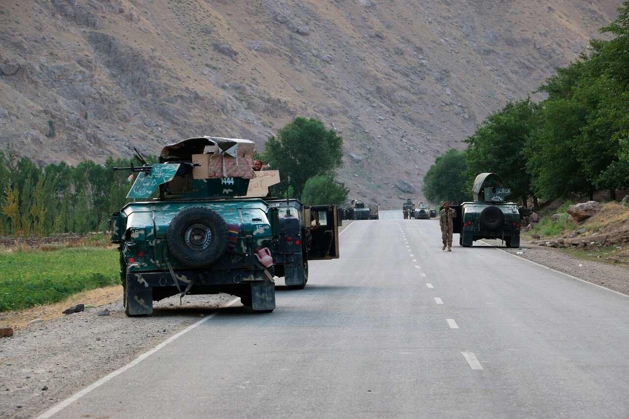 Afghan soldiers pause on a road at the front line of fighting between Taliban and Security forces, near the city of Badakhshan, northern Afghanistan.