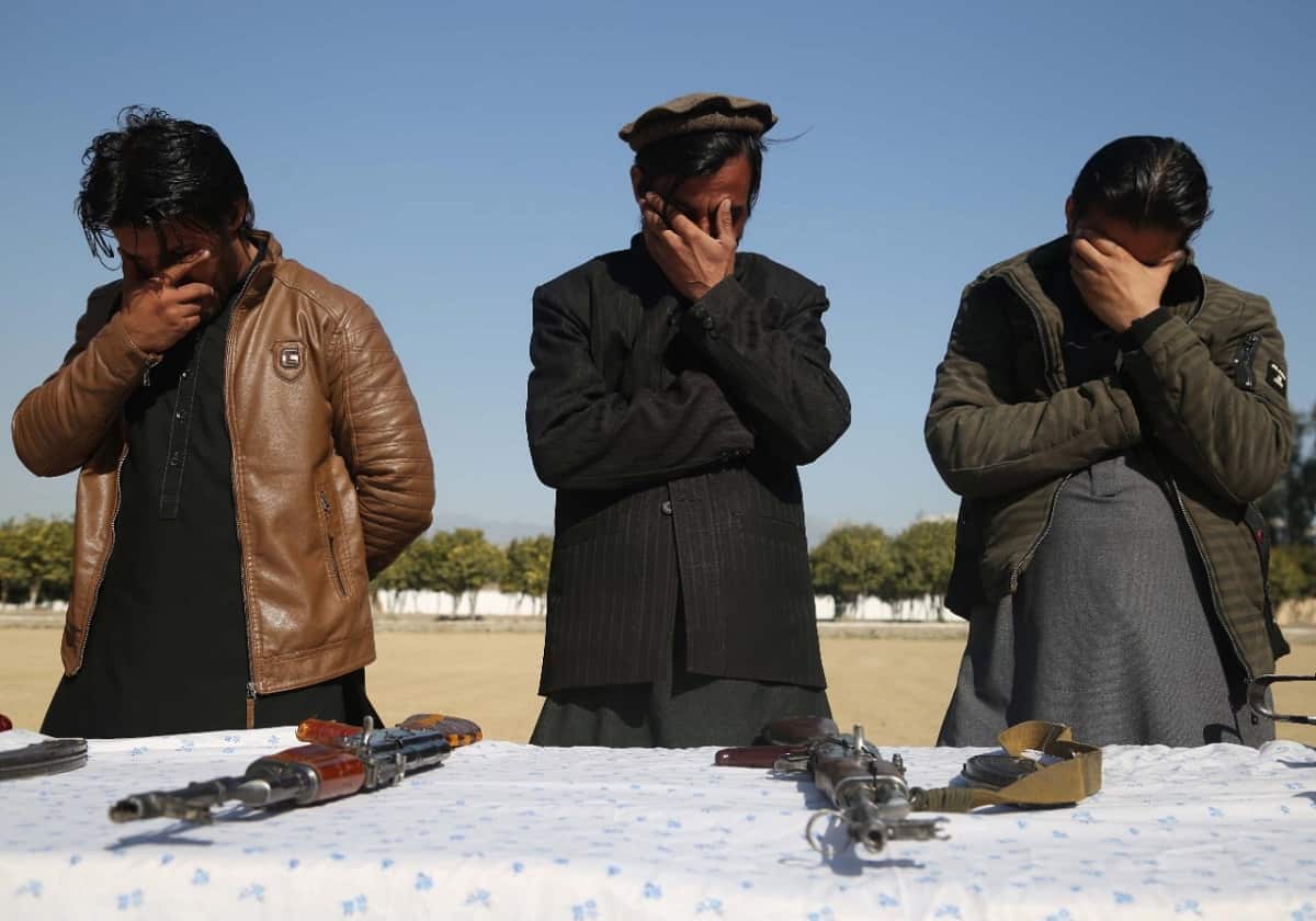 Former militants surrender their weapons during a reconciliation ceremony in Jalalabad, Afghanistan, 8 February 2020.