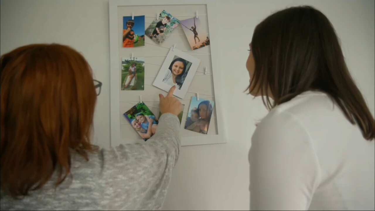 Taryn shows SBS News photos of her children. 