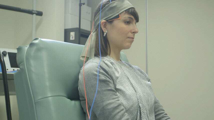 A volunteer is strapped to a transcranial direct current stimulation (tDCS) machine at the Black Dog Institute. (SBS)